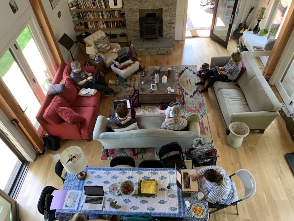 View of the writer's studio from above - people sitting on sofas writing  